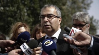Cyprus Central Bank Governor Panicos Demetriades makes statements outside the parliament in Nicosia