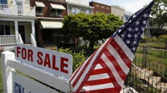 A U.S. flag decorates a for-sale sign at a home in the Capitol Hill neighborhood of Washington