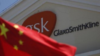 A Chinese national flag is seen in front of a GlaxoSmithKline office building in Shanghai, July 12, 2013
