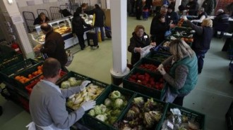 People receive food that is either too old or not looking nice enough for sale at the non-profit Dortmund food bank in the western German city of Dortmund