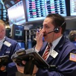Dow sets record close as Fed says rates to stay low 