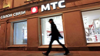 A man walks past a MTS shop in St.Petersburg March 18, 2013. REUTERS/Alexander Demianchuk