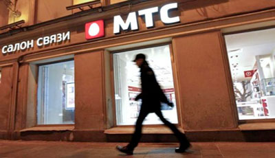 A man walks past a MTS shop in St.Petersburg March 18, 2013. REUTERS/Alexander Demianchuk