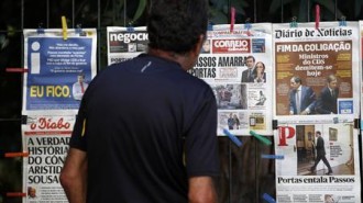 A man reads the front pages of various newspapers announcing Portugal's central bank's decision to rescue troubled lender Banco Espirito Santo (BES) in a 4.9 billion euro ($6.6 billion) recapitalisation in Lisbon in this August 4, 2014 file photo. REUTERS/Hugo Correia/Files