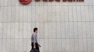 A man walks past OCBC bank in Singapore's central business district, August
