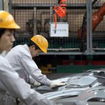 China Factory Gauge Rises as Workers Weather Slowdown