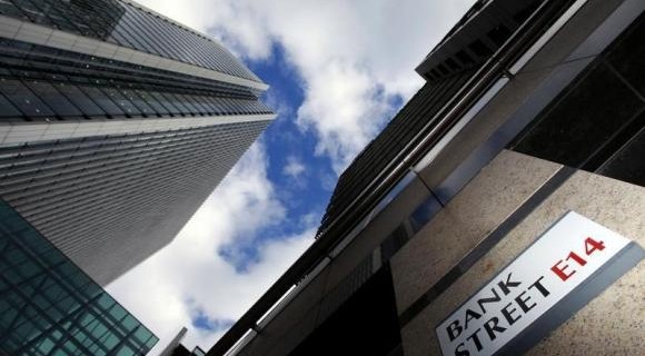 A sign for Bank Street and high rise offices are pictured in the financial district Canary Wharf in London