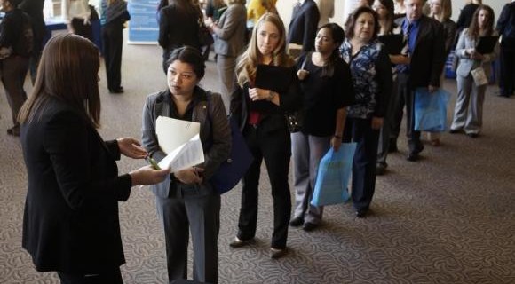 Jobseekers wait to talk to a recruiter at the Colorado Hospital Association's health care career event in Denver