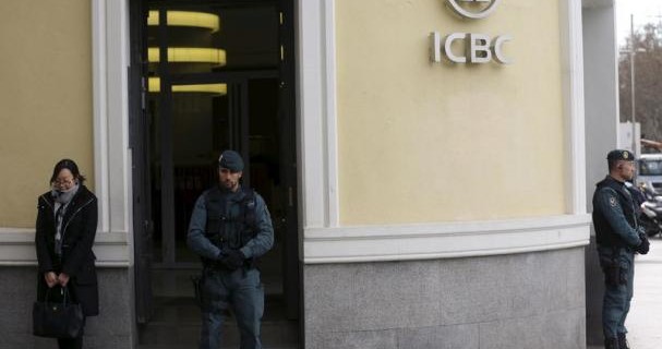 Spanish Civil Guard officers stand in front of the entrance of the headquarters of Industrial and Commercial Bank of China during a raid in Madrid