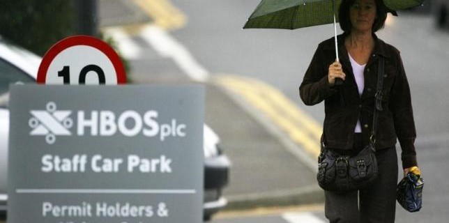 A worker leaves HBOS offices in Edinburgh, Scotland