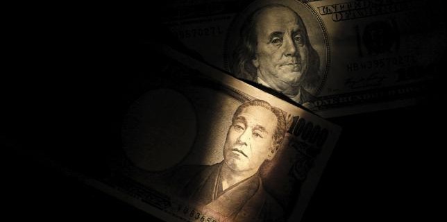 Light is cast on U.S. one-hundred dollar bill next to Japanese 10,000 yen note in Tokyo