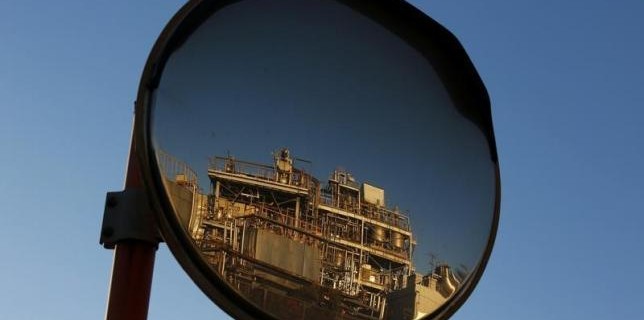 A petro-industrial factory is reflected in a traffic mirror in Kawasaki near Tokyo