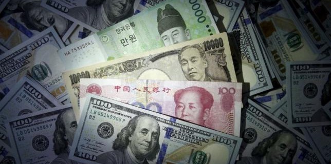 File photo illustration of South Korean won, Chinese yuan and Japanese yen notes seen on U.S. 100 dollar notes
