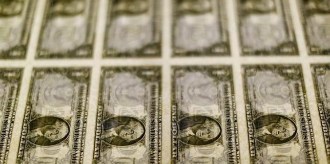 File photo of United States one dollar bills seen on a light table at the Bureau of Engraving and Printing in Washington