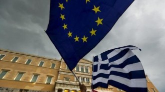Protesters wave Greek and EU flags during a pro-Euro rally in front of the parliament building, in Athens