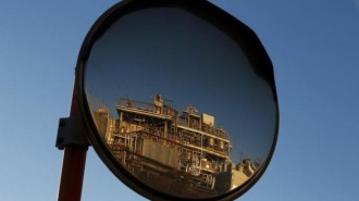 A petro-industrial factory is reflected in a traffic mirror in Kawasaki near Tokyo