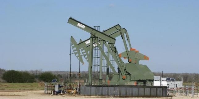 A pump jack used to help lift crude oil from a well in South Texas’ Eagle Ford Shale formation stands idle in Dewitt County Texas