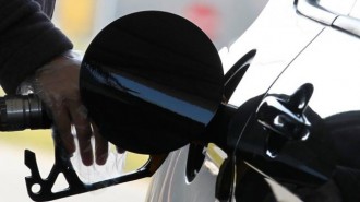 A driver pumps petrol into his car at a petrol station in Brussels