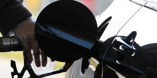 A driver pumps petrol into his car at a petrol station in Brussels