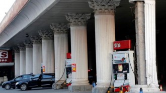 Cars wait to fill with fuel at Sinopec's fuel station in Beijing