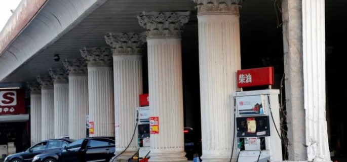 Cars wait to fill with fuel at Sinopec's fuel station in Beijing