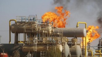 Flames emerge from a pipeline at the oil fields in Basra, southeast of Baghdad