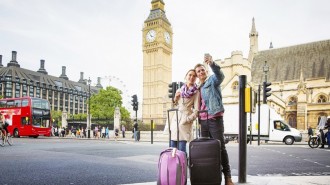 Young tourist couple shoots selfie Big Ben London UK
