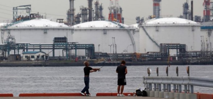 Men fish near an oil refinery in Kawasaki