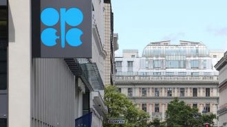 The OPEC flag and the OPEC logo are seen before a news conference in Vienn