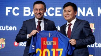 FC Barcelona's President Josep Maria Bartomeu and Rakuten's President and CEO Hiroshi Mikitani pose with a jersey after signing a contract as main sponsor in Barcelona