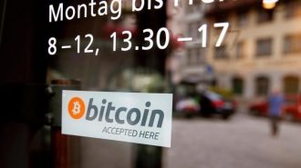 A sticker that reads "Bitcoin accepted here" is displayed at the entrance of the Stadthaus town hall in Zug