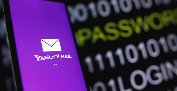 Yahoo Mail logo is displayed on a smartphone's screen in front of code in this illustration picture