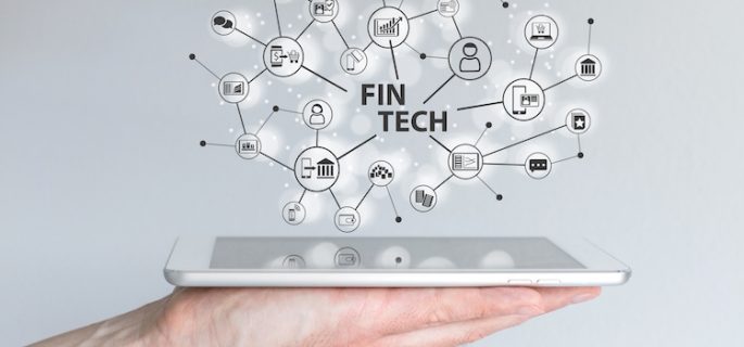 Fin Tech and mobile computing concept. Hand holding tablet