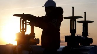 Oil Prices, A worker checks the valve of an oil pipe at Lukoil company owned Imilorskoye oil field outside the Siberian city of Kogalym