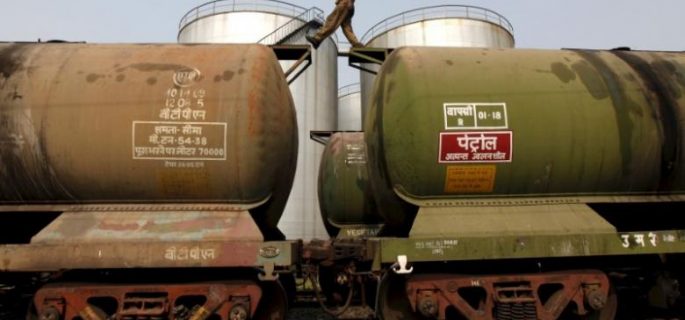 FILE PHOTO: A worker walks atop a tanker wagon to check the freight level at an oil terminal on outskirts of Kolkata