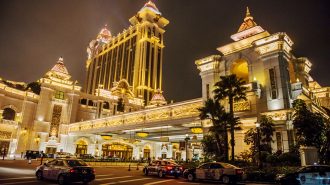 Taxis sit parked in front of the Galaxy Macau casino and hotel in Macau, China